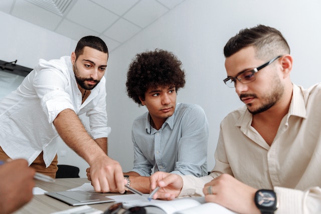 three experts looking a marketing plan during a meeting